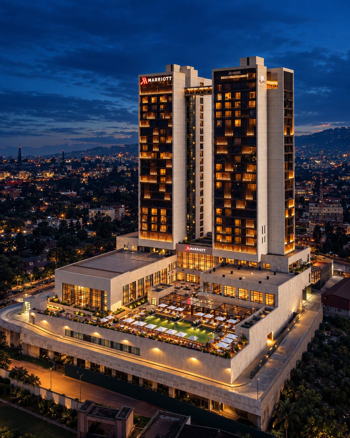 Marriott hotel tower with warm golden lights overlooking the city at blue hour